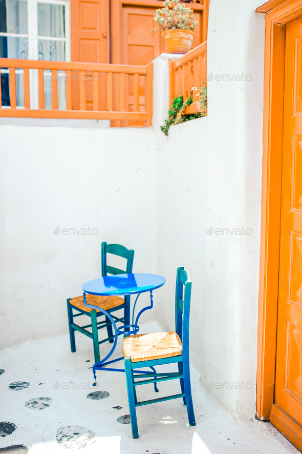 Blue Chairs And Table On Street Of Typical Greek Traditional Village With White Houses On Mykonos Stock Photo By Travnikovstudio