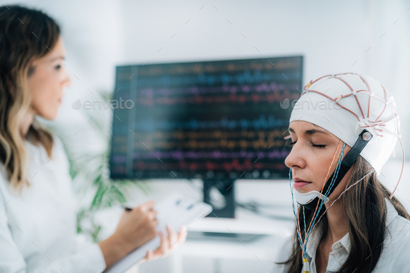 Female Patient in a Neurology Lab doing EEG Scan Stock Photo by microgen