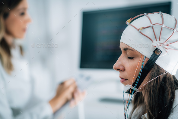 Female Patient in a Neurology Lab doing EEG Scan Stock Photo by microgen