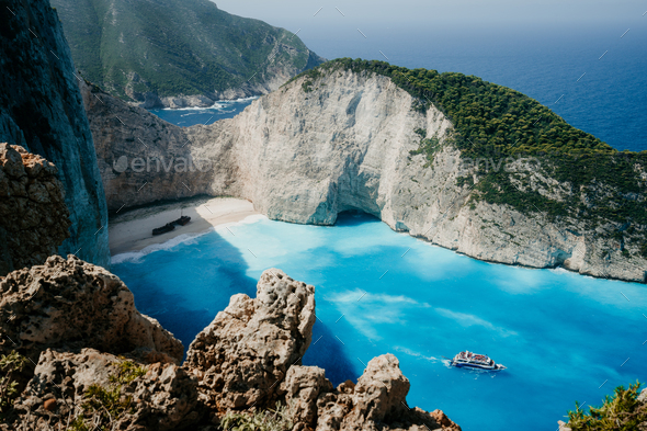 Navagio beach or Shipwreck bay with turquoise water and pebble white beach. Famous landmark location - Stock Photo - Images