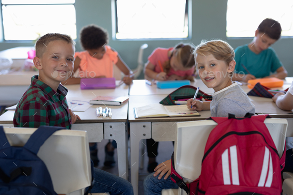 Schoolboys sitting at desks in an elementary school classroom