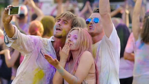 Happy Friends Filming Greeting From Open-Air Music Festival on Smartphone Camera alt