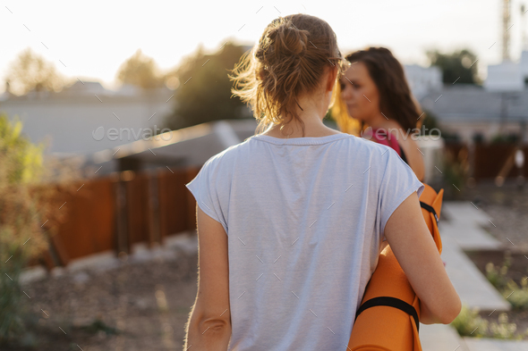 Two young beautiful women in sportswear going to do sports training, gymnastics, yoga - Stock Photo - Images