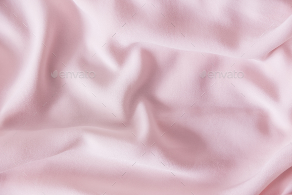 Pink wrinkled silk fabric. The pink fabric is laid out waves. Pink fabric  background or texture. Stock Photo by Vladdeep