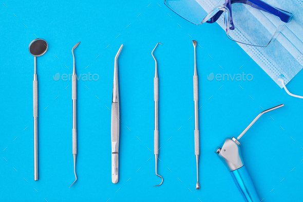 Dentist tools over blue background top view Stock Photo by haveseen