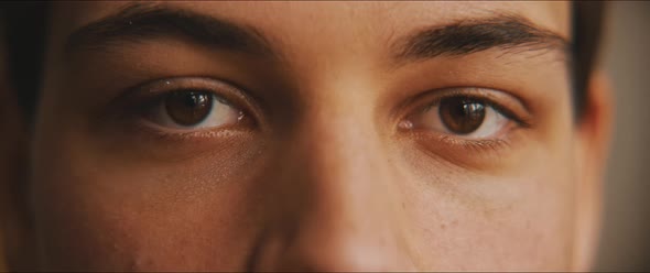 Closeup of a young man eyes staring at the camera alt