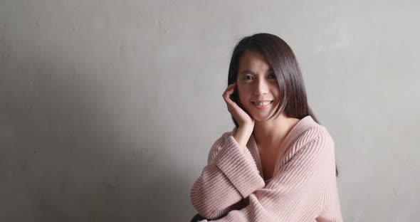 Asian woman smile to camera over gray background alt