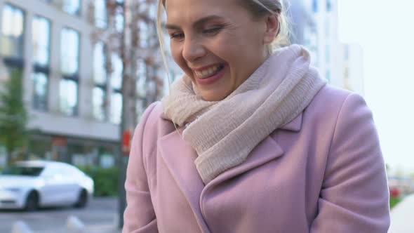 Happy Woman Admiring Daughter in Bike Helmet Outdoors Stroking Child Face, Love