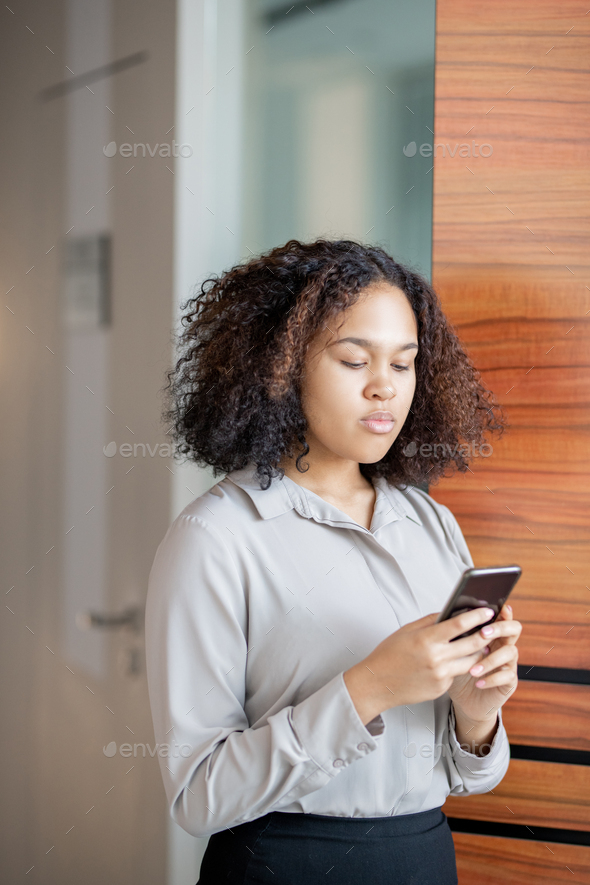 Afro-American woman using smartphone