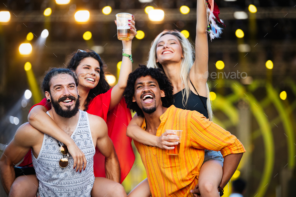 Group of friends having fun time at music festival Stock Photo by nd3000