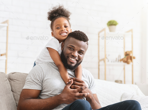 Beautiful afro family of two posing at home