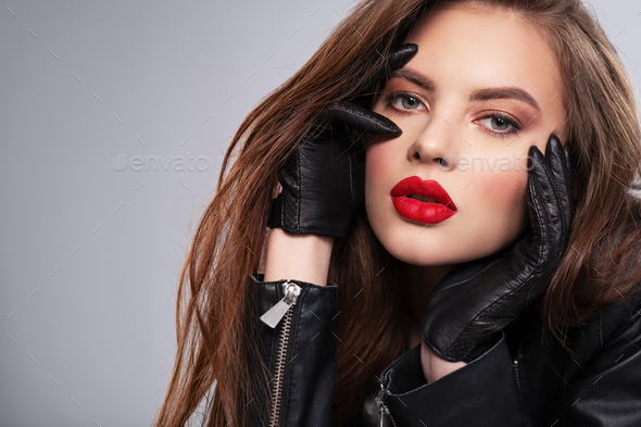 Beautiful brunette with bright red lipstick on her lips. Stock Photo by  valuavitaly