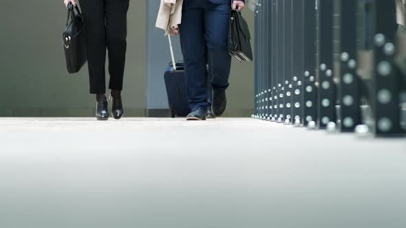 People in suits going in terminal