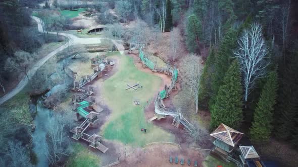 Park in Forest With Wooden Statues of Gnomes, Monsters.  Aerial View of the Wooden Castle 4K Video alt