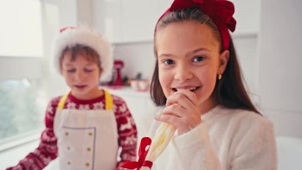 Happy Kids Girl and Boy Making Homemade Cake for Christmas at Light Home Interior alt