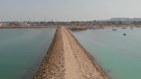 Aerial forward shot of beautiful empty Coastal Highway along Pakistan's Arabian Sea coast from Karac alt