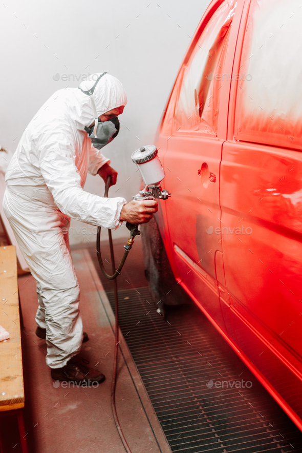 mechanic engineer painter painting a car using a car sprayer, airbrush compressor