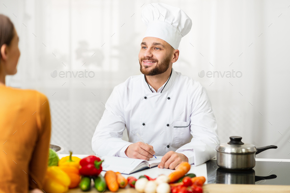 Professional Chef Man On Job Interview Talking With Woman In Kitchen