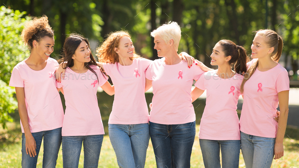 Women In Pink Ribbon T-Shirts Embracing Standing Outdoor, Panorama