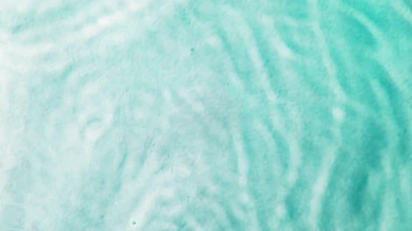 Super Slow Motion Shot of Clear Cyan Sea Surface Waving Over White Sand Beach at 1000Fps alt