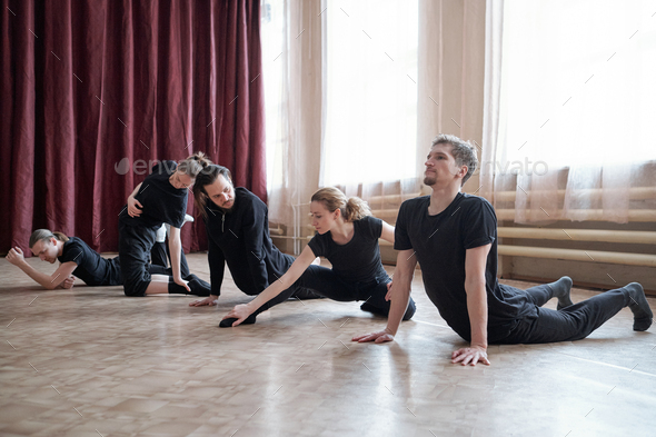 Professional Dancers Doing Stretching Exercise