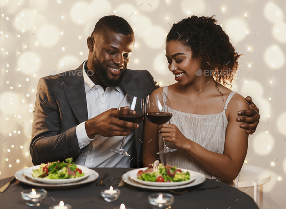 Married black couple celebrating anniversary in fancy restaurant