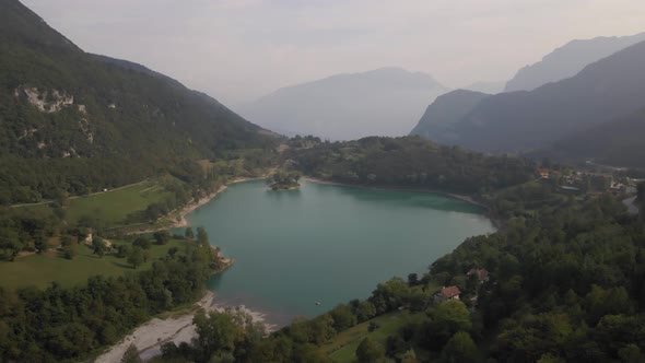 Aerial view of Tenno lake, Trentino, North Italy. Green landscape during a sunny day. Lake overview alt