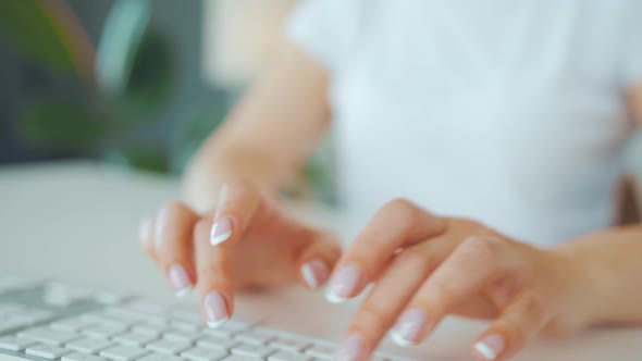 Female Hands Typing on a Computer Keyboard alt