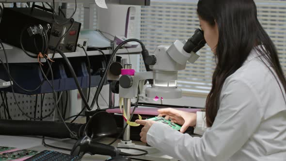 Female Technicians Working with Electronic Details alt