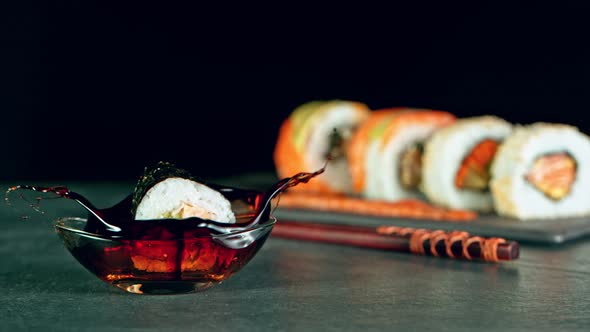 Super Slow Motion Shot of Fresh Sushi Falling Into Soy Sauce at 1000Fps. alt