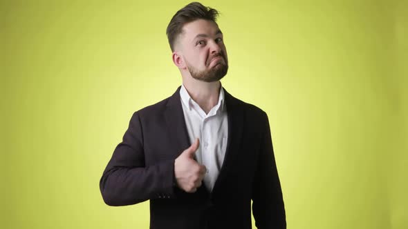 Handsome Bearded Young Man in Office Suit Says Wow and Shows Thumb Up Gesture