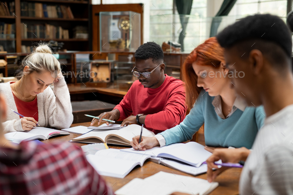 Group of university students studying together Stock Photo by Rido81
