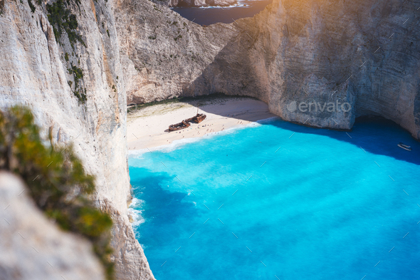 Navagio beach with turquoise blue sea water surrounded by huge white cliffs. Famous landmark - Stock Photo - Images