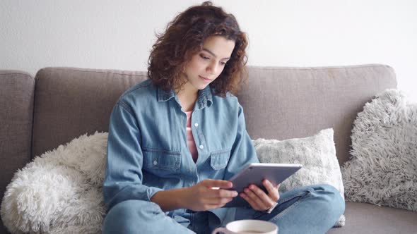 Young Woman Using Computer Tablet and Working and Studying Online alt