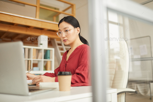 Modern Asian Businesswoman Using Laptop
