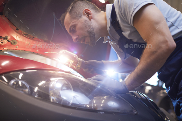 Professional Mechanic Inspecting Car in Auto Shop