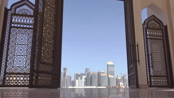 Skyscrapers of Doha through the Openwork Door of the Mosque