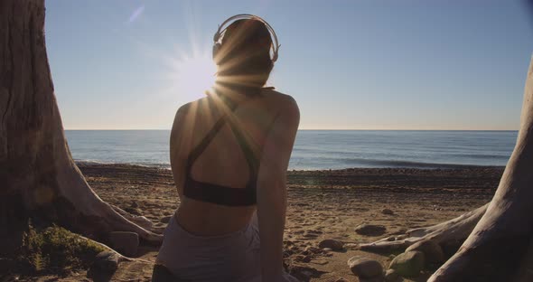 Woman Relaxing On Beach At Sunset alt