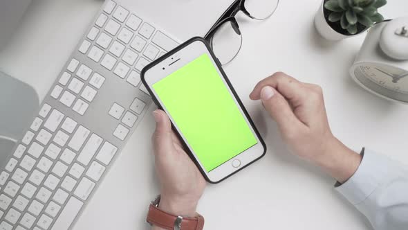 Businesswoman 's hands  working and touch screen the green screen on smartphone