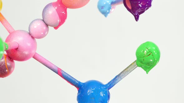 Close Up Colorful Ink On The Round Balls On White Background. alt