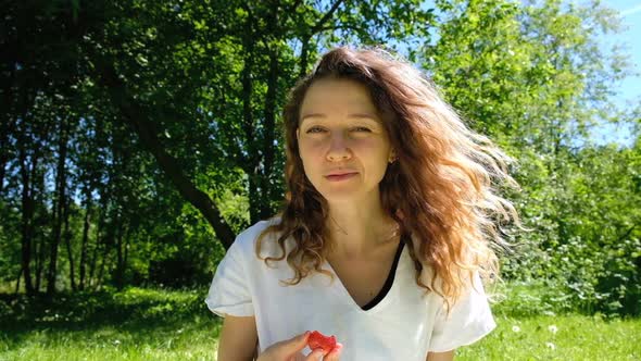 European Girl Eating Strawberries in Nature Slow Motion alt