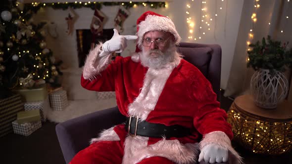 Funny Santa Claus Shoots Himself From the Hand As If It Is a Gun. The Difficult Year 2020 Is Ending.