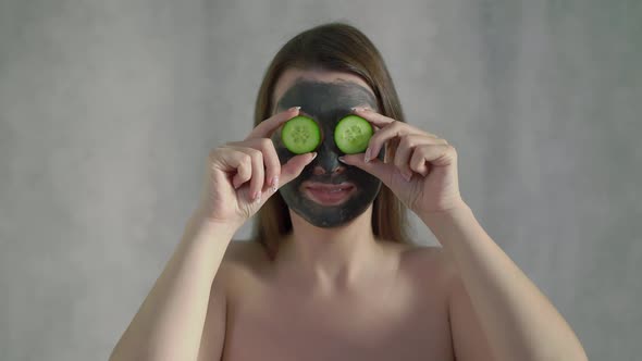 Young Woman Takes Care of Skin of Face