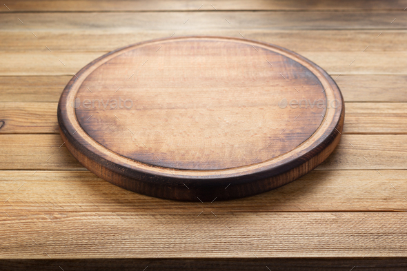 pizza cutting board at rustic wooden table Stock Photo by seregam