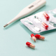 Antibiotic and thermometer. Highly blurred background photo. - PhotoDune Item for Sale