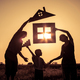 Happy family standing on the field at the sunset time. They build a house. - PhotoDune Item for Sale