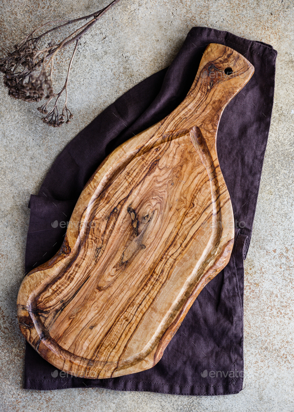 Wooden cutting board on a kitchen table. The concept of rustic kitchen