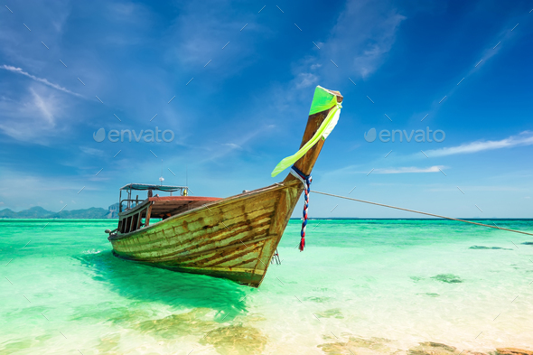 Thai traditional wooden boat at ocean shore Thailand - Stock Photo - Images