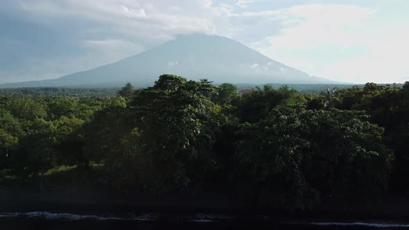 mount agung reveals on the shoreline green rainforest alt