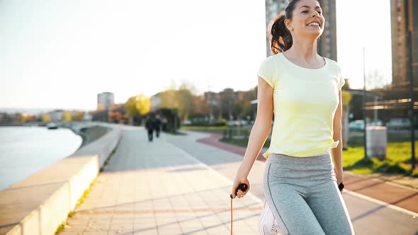 Sportswoman Using Jumping Rope to Stay Fit Outdoor
